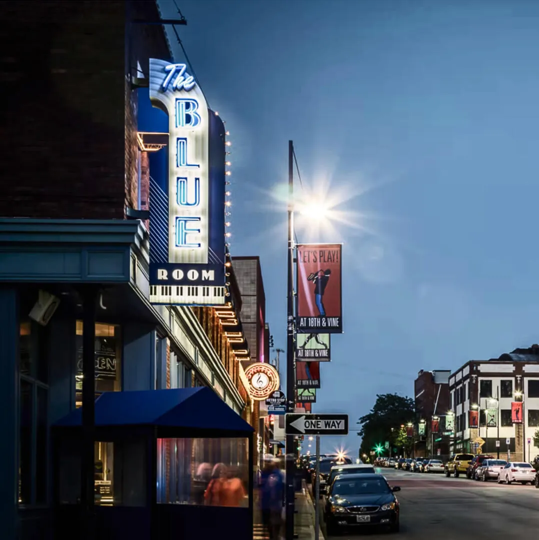 The Blue Room’s neon sign on 18th Street at dusk
