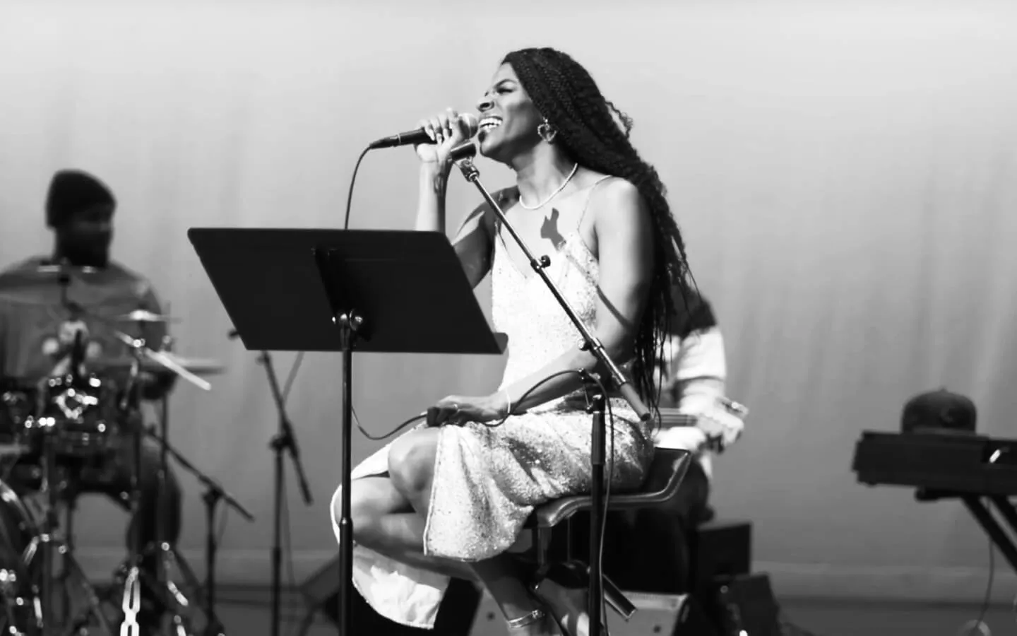 A vocalist performing with her band at the American Jazz Museum